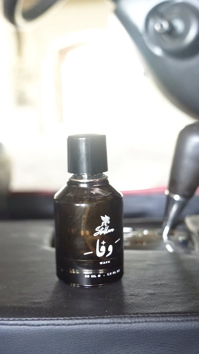 The Wafa flacon on a dashboard, a still from the film