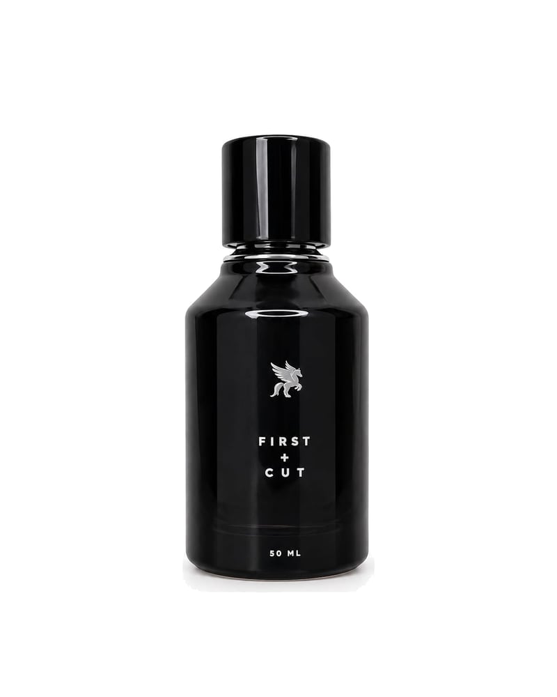 First + Cut eau de parfum, the black Stellare flacon on a white ground