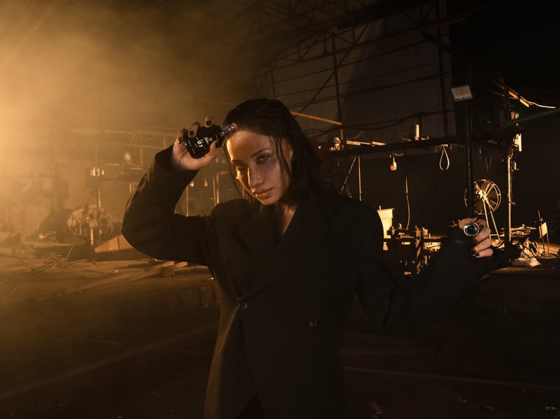 A woman crouched beside the burning ring, the flacon in her hand